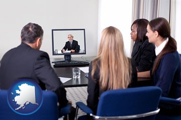 businesspeople participating in a video conference - with Alaska icon