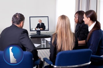 businesspeople participating in a video conference - with Delaware icon