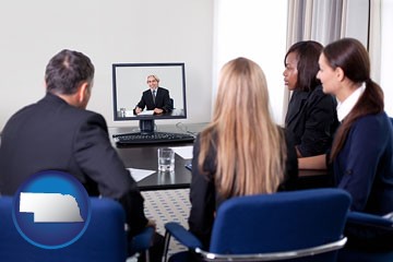 businesspeople participating in a video conference - with Nebraska icon