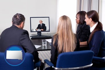 businesspeople participating in a video conference - with South Dakota icon